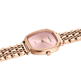 Rose gold watch with pink face on a white background