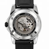 A close-up studio shot of a wristwatch back case with a transparent dial, showing the silver stainless steel movement and internal components. The watch has a black strap and a silver-toned case, with text on the dial reading 'JAPAN MOVEMENT', '3 ATM WATER RESISTANT', and 'ALL STAINLESS STEEL'.