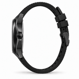 A black automatic watch shown from the side profile, featuring a matte black case and a textured black silicone strap with a matching black buckle, set against a plain white background.